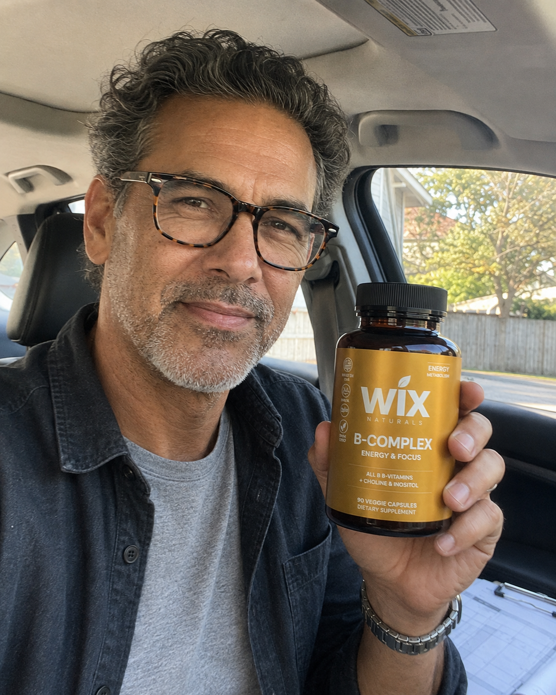 Daniel holding WIX Naturals B-Complex before a project site visit